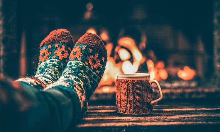 winter socks and mug in front of fireplace.