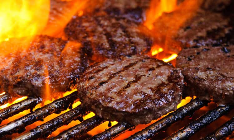 closeup of hamburgers on grill.