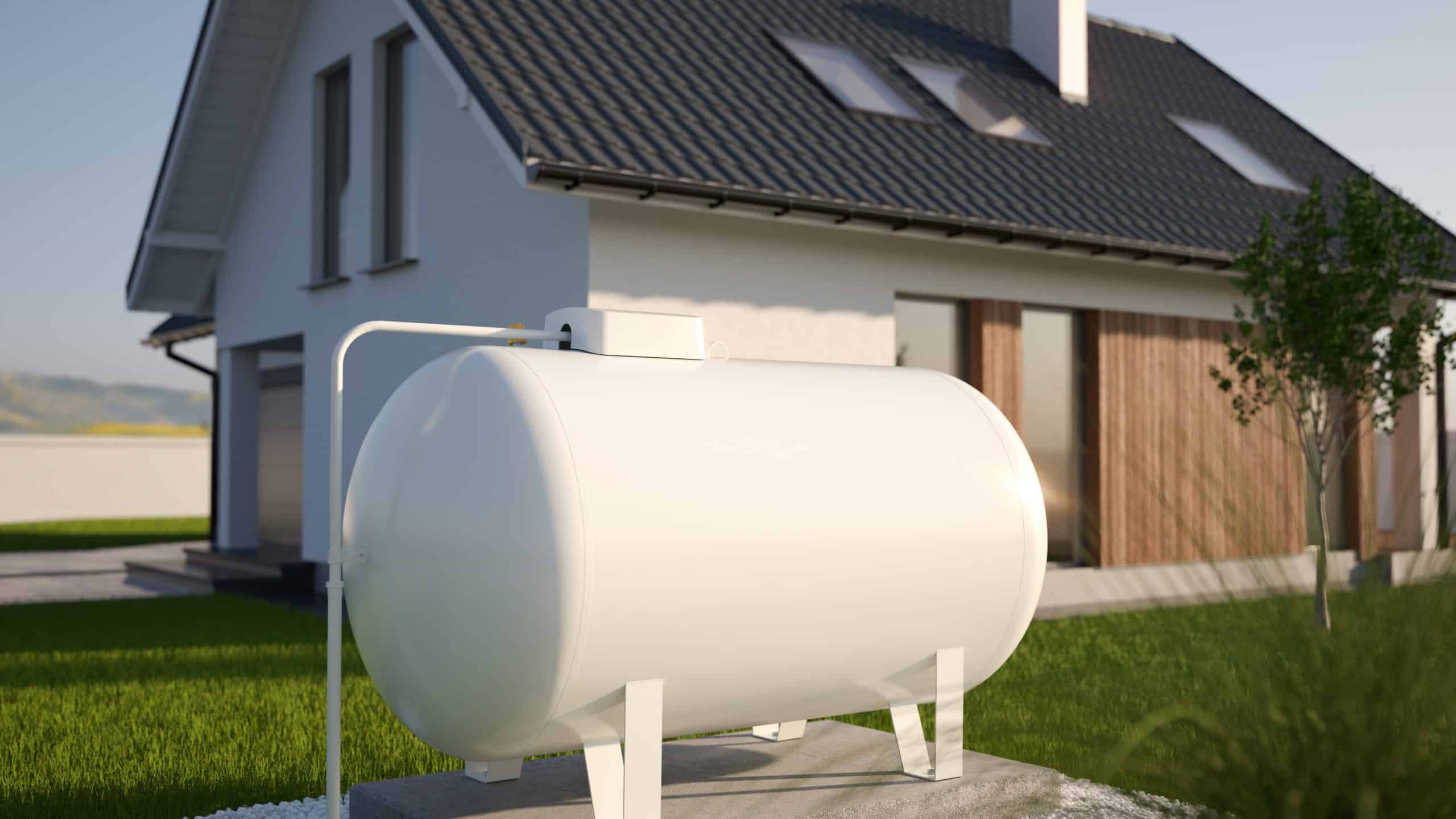 A large white propane tank is situated outdoors in front of a modern house with a grey roof and wooden accents. The lawn is green and well-kept, demonstrating the convenience of reliable propane services.