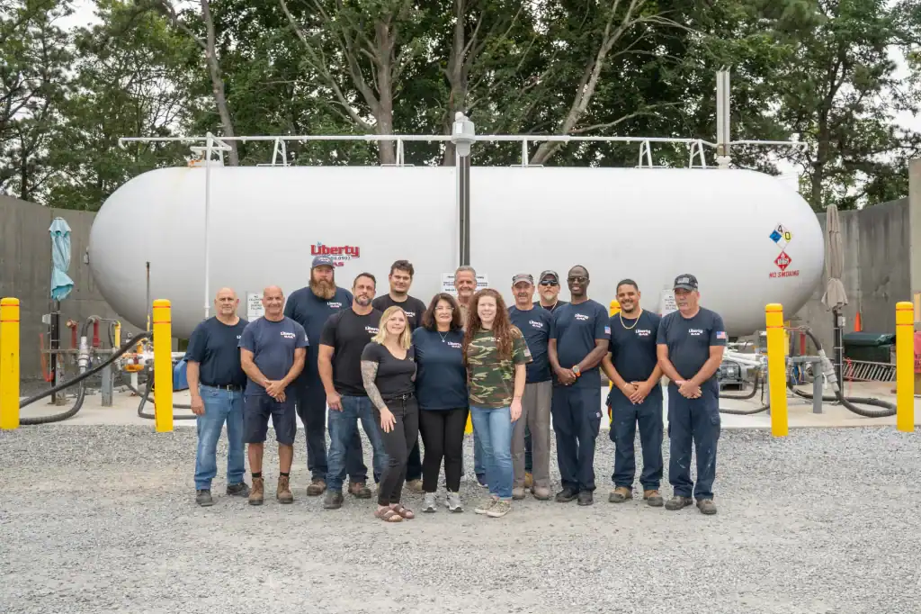 Group photo of the Liberty Gas Service outdoor team in Suffolk County, New York, showcasing professionalism and teamwork in a beautiful natural setting